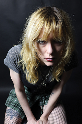 Photograph of a girl in punk rocker clothes.